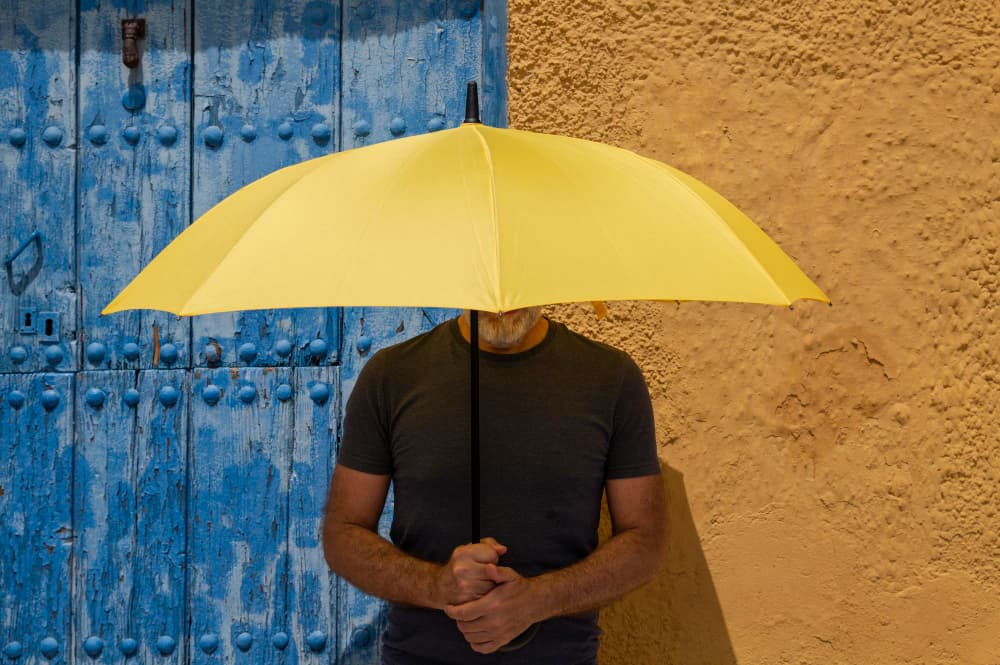 man_outside_with_umbrella_after_dhi_in_turkey