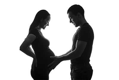 man_touching_pregnant_womans_stomach_after_ivf_in_turkey